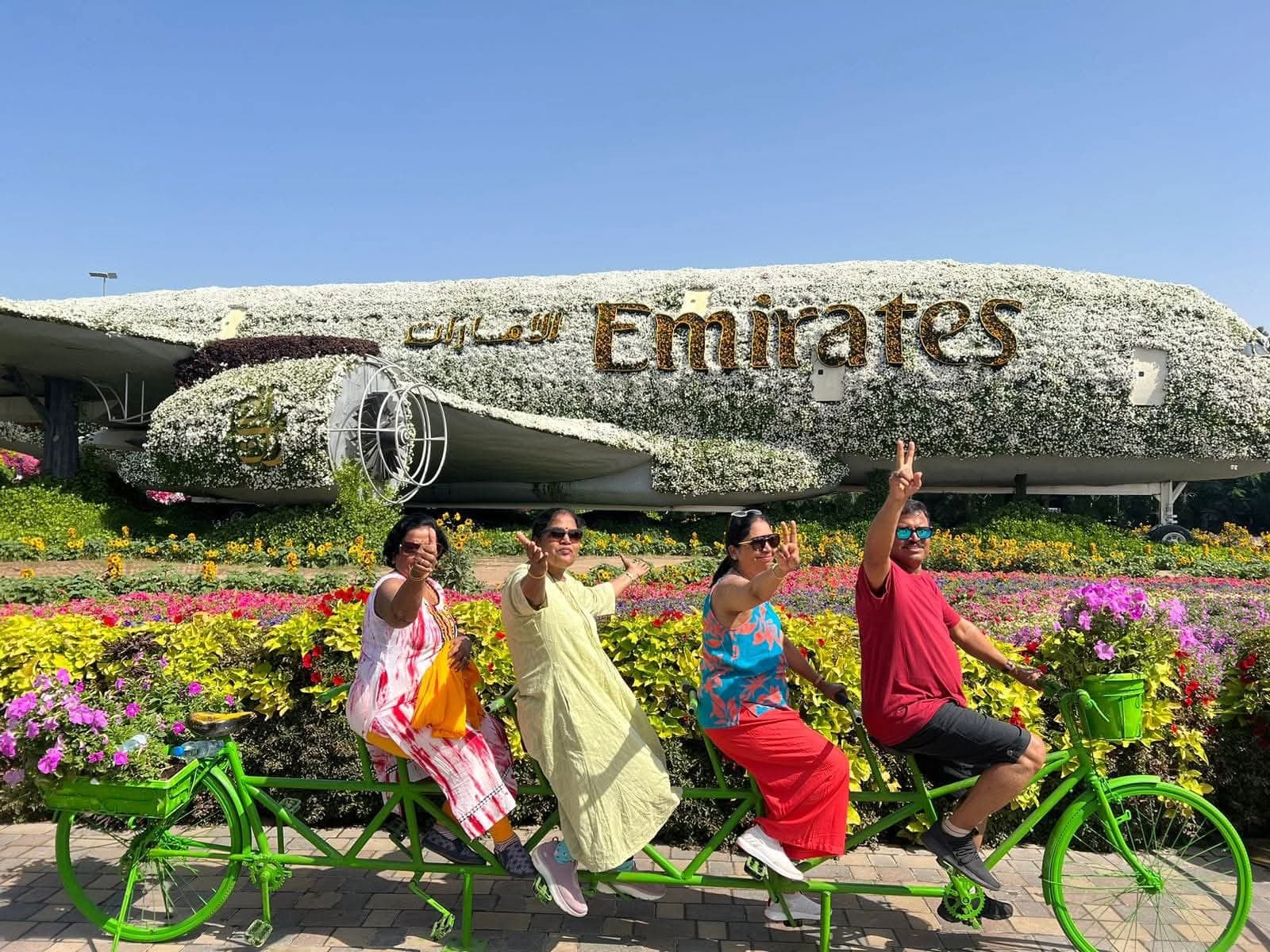 Group posing in front of airplane